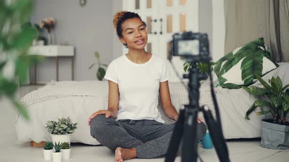 Female Blogger Is Recording Video for Videolog Looking at Camera, Smiling and Talking Emotionally