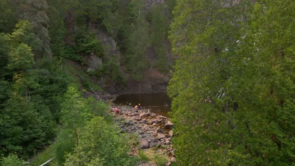 Beautiful hidden waterfall in North Minnesota with people visiting it, summer vacation places to go