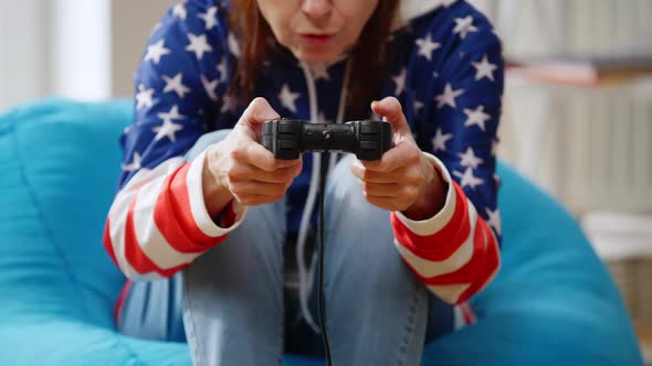 Unrecognizable Female Retiree Gaming Online Pressing Game Controller