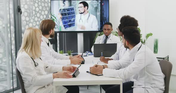 Mixed Race Male and Female Medical Workers which Having Online Conference