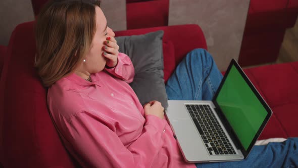 Close Up Bored Woman Looking at Laptop with Green Screen Tired Woman Yawning and Sitting on the