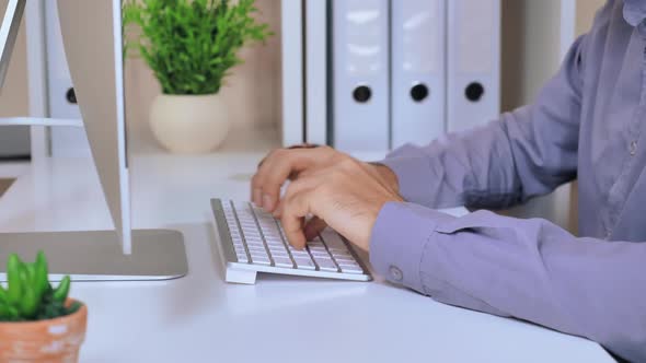 Closeup Male Employee Entering Data on PC