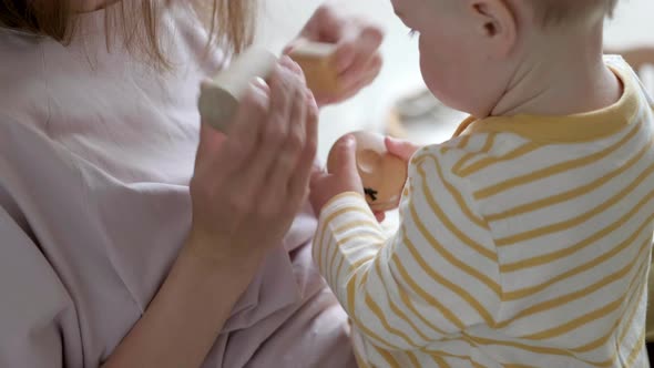 Little Baby Girl and Mommy Playing Wooden Eco Toys at Home