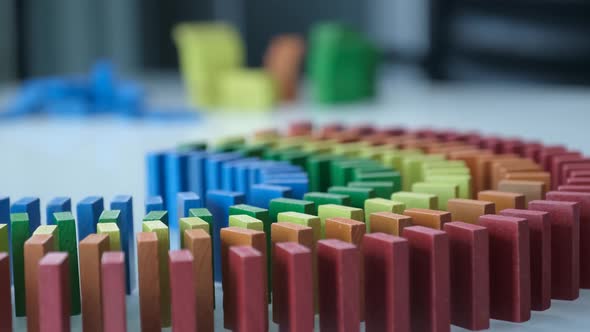 Line up of Dominoes in Rainbow Falling Colors with LGBT Colors of a Hand