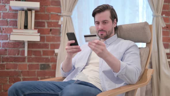 Casual Young Man Unsuccessful Online Payment on Smartphone