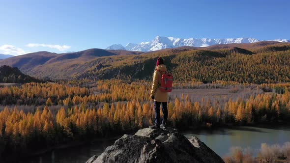 Backpacker in Golden Autumn in Altai Mountains, Siberia, Russia