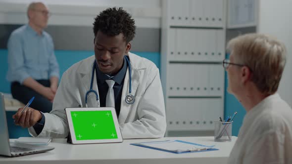 Medic Using Professional Tablet with Horizontal Green Screen