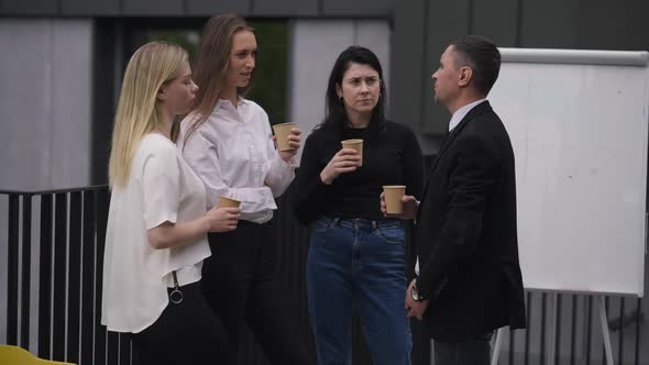 Coffee Break of Confident Caucasian Coworkers Outdoors