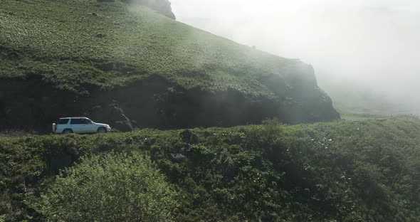 Misty Sky Against Tskhratskaro Pass With Driving Car In Ktsia-Tabatskuri Managed Reserve In Georgia.