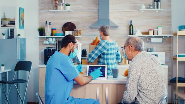 Elderly Man Talking with Doctor