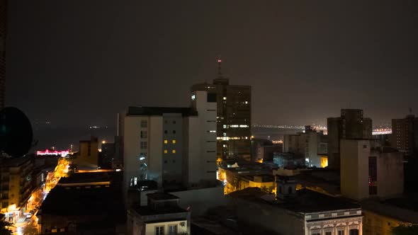 Timelapse of night to dawn in Asuncion, waking up with the streets and building lights changing thro