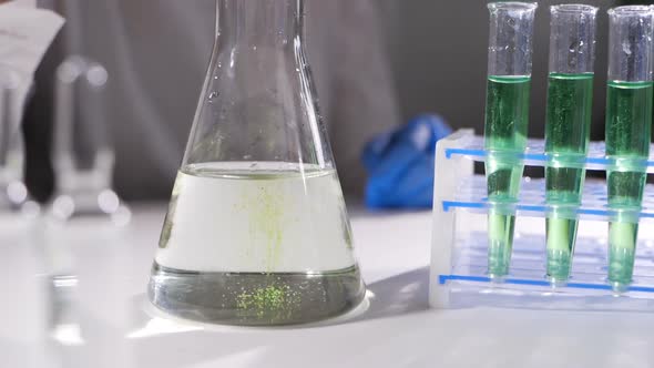 Chemical Test in Laboratory, Scientist Performing Chemical Liquid Test in Laboratory. alt