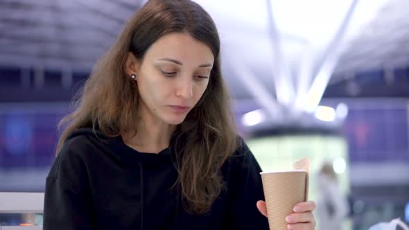 A Girl Holding a Cup of Coffee in Hand