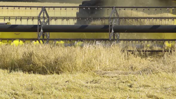 A Close Up Detailed View of a Front a Combine Harvester As It Harvests Grains.