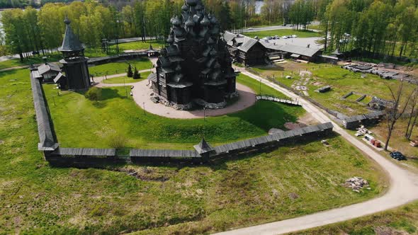 Wooden Temple Built on Outskirts of City Against Buildings