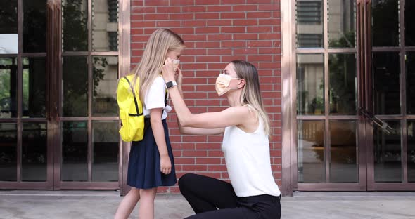 Happy Little Caucasian Blonde Girl Seven Years Old in Uniform with Yellow Backpack Going Back to