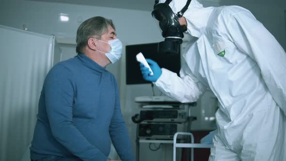 Paramedic Is Using a Special Device To Measure Patient's Temperature. COVID 19, Virus, Coronavirus