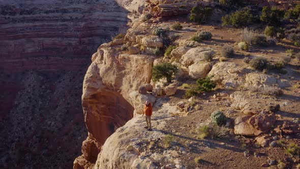 Aerial shot of a hiker at the the edge of Cedar Mesa in Utah