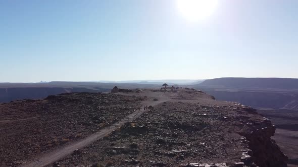 People are walking to the watch point on top of the cliff, Fish River Canyon