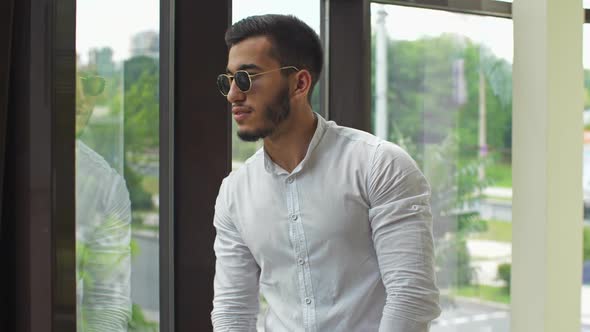 Young Businessman Look Through the Window