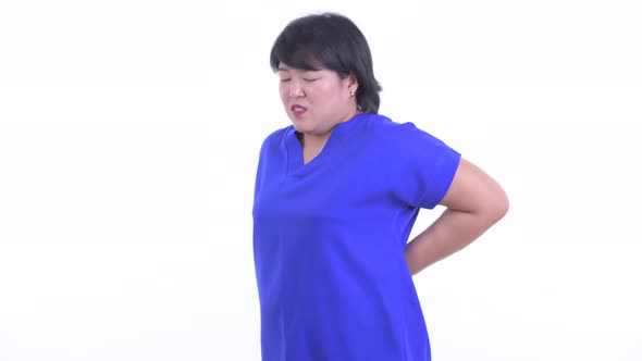 Stressed Overweight Asian Businesswoman Having Back Pain