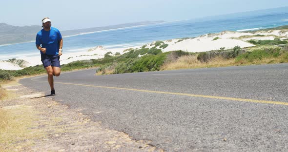 Triathlete man jogging in the countryside road