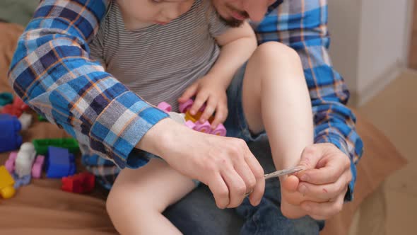 Dad Cuts His Daughter's Toenails