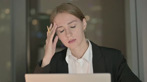 Close Up of Businesswoman Having Headache in Office at Night