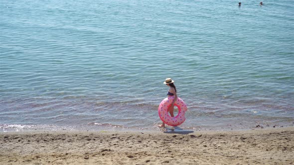 Young Woman in White on the Beach