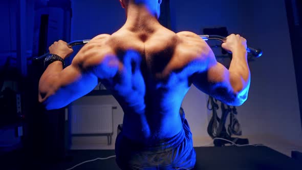 Brutal strong athletic men pumping up muscles. Doing workout on sport equipment