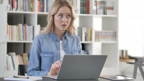 Thinking Young Girl Working on Laptop