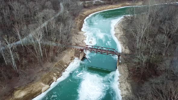 Wintry Cliffs, Mountains, Icy River, and Footbridge