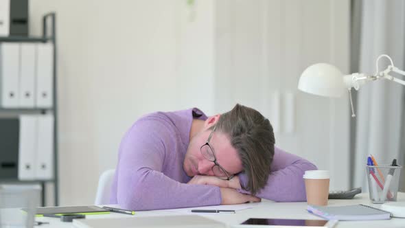 Middle Aged Man Taking Nap on Table