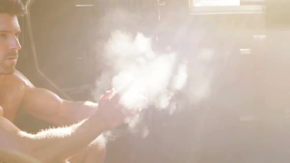 Man dusting his hands with chalk powder