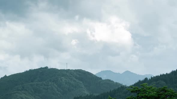 Timelapse of clouds over mountains.