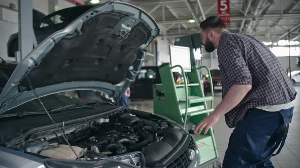 Examining Car Engine