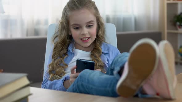 Girl Texting Message on Smartphone Sitting on Chair, Social Networks, Addiction