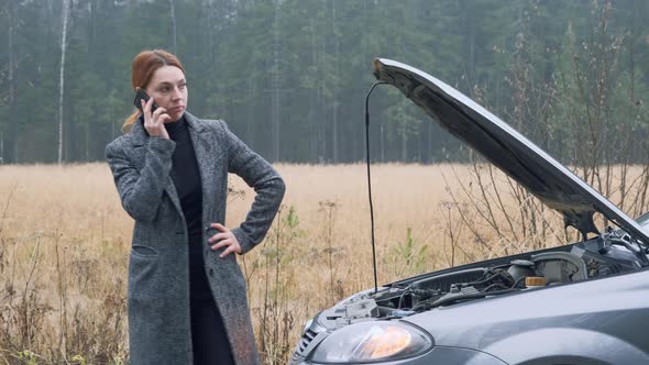 Young Business Woman on Countryside Road Trying To Get Help