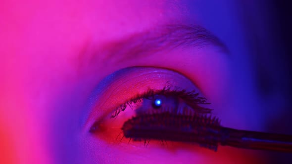 Modern Young Woman Applies Mascara Closeup