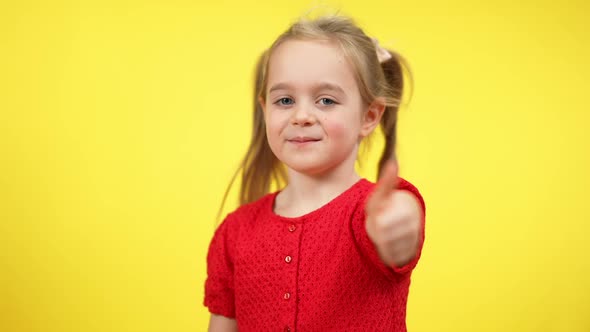 Confident Smiling Girl Showing Thumb Up Looking at Camera