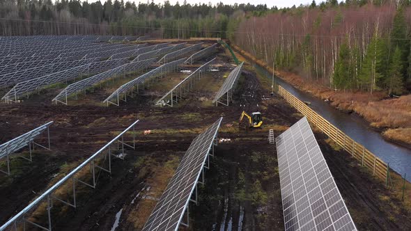 excavator drives to work in sun power plant