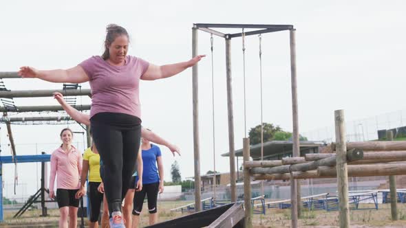 Caucasian woman exercising at bootcamp