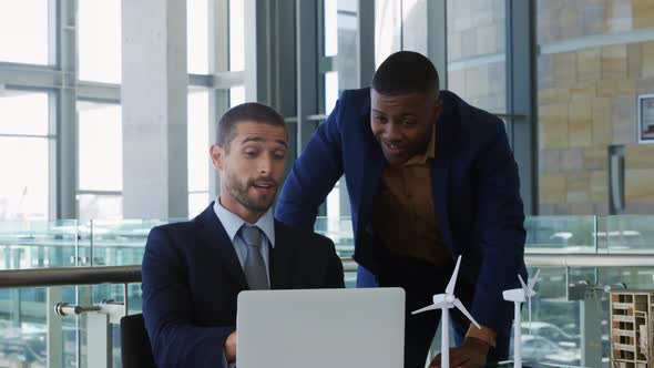 Young businessmen using laptop in a modern office