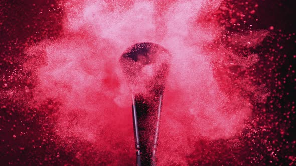 Make up brush and colored powder/particles exploding. Slow Motion. alt