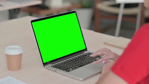 Young Blonde Woman Using Laptop with Green Screen