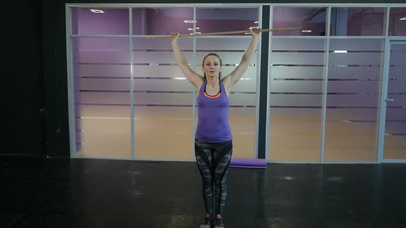 Fitness Woman Doing Stretching and Warmup Workout at Fitness Gym. Young Woman Exercising Fitness.