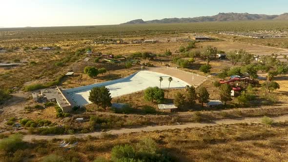 Wide descending drone shot of abandoned waterpark Breakers in Tucson Arizona