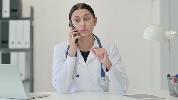 Female Doctor Talking on Phone in Clinic