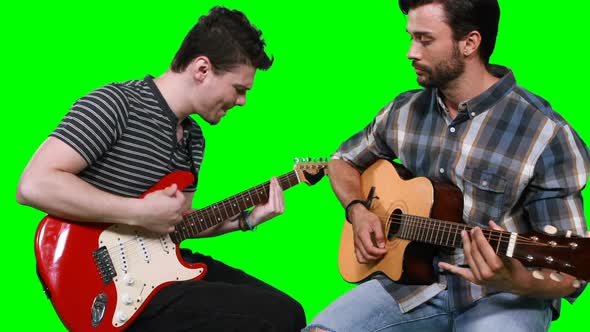 Male musicians playing guitar
