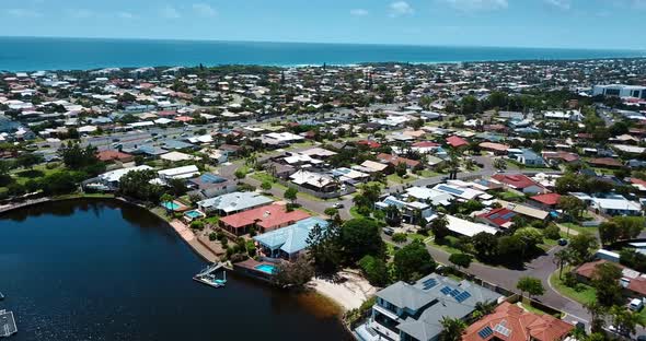 Flying above Gold Coast residential area and shore.